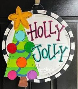 door hanger with a green Christmas tree displaying Holly Jolly